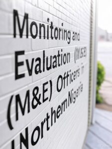 generate a simple image for this it\generate a simple image the text should appear on the wall: Monitoring and Evaluation (M&E) Officers in Northern Nigeria